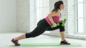 The girl performs the exercise with dumbbells